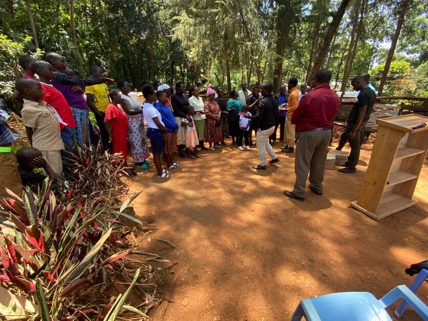 Members of Itibo Young Faith Christ Fellowship meeting beneath trees